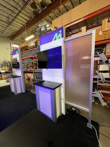 RENTAL: Modified RE-9127 Island Design with Storage Closet with Locking Door, 6 x 12 Double-Sided Lightbox, (4) 3 x 8 Single-Sided Lightboxes with Frosted Extrusion Accent Wings,  (4) LED Arm Lights, (4) RE-1227 Workstation Counters, RE-1207 Large Rectang