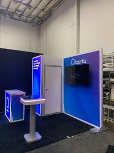 RENTALS: RE-1077 Gravitee System Design with Locking Storage Closet, Large Monitor Mount, RE-1567 Backlit Gravitee Counter, RE-710 Charging Station, 55" Monitor, and SEG Fabric Graphics