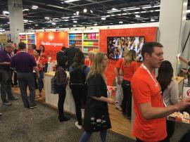 Custom Wood Exhibit with Shelves, Cabinets, SEG Graphics, Lighting, and MOD-1450 Charging Table with Graphics