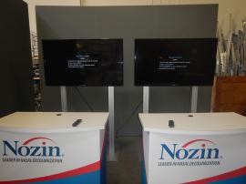 RENTAL: (2) RE-1229 Large Monitor Kiosks with Black Laminated Shelves on Back Side, (2) 55" Monitors, (2) RE-1558 Gravitee Counters with Locking Doors and Interior Shelves, and Silicone Edge Fabric Graphics for Counters