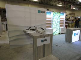 Custom Eco-Systems Modular Inline Exhibit with Multiple LED Lightboxes, Storage Closet, Slant Shelving, Monitor Mount, Slant Shelving, Backlit Reception Counter, (4) MoD01329 iPad Swivel Stands, and (4) Charging Ports