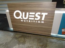 Custom Island Exhibit with Custom Counters, LED Perimeter Lighting and Logos, Locking Storage, Product Shelves, and Reception Counter