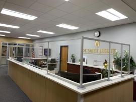 Custom Office Safety Partitions for a Large Administrative Counter Constructed with Engineered Aluminum and Clear Acrylic