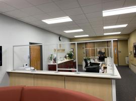 Custom Office Safety Partitions for a Large Administrative Counter Constructed with Engineered Aluminum and Clear Acrylic