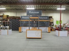 Custom Peninsula Island Exhibit with Gravitee Modular Panels (backwall), Laminated Bridge with Pendant Lights, Prep Counters with Storage, Reception Counter with Storage, Interior and Exterior Shelves, Locking Closet, and 3-sided Graphic Façade for Produ