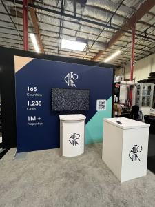 RENTAL: RE-1080 1nline Includes (1) Large Monitor Mount, 48 inch Monitor, RE-1219 Square Pedestal with White Laminated Top, RE-1221 Workstation Counter with White Laminated Top, SEG Fabric Graphic, Direct Sintra Print Graphics.