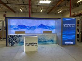 Custom Inline Exhibit with Backlit Fabric Graphics, Backwall Curved Counter, Vinyl Graphics. Puck Lights, Closet Storage, and ECO-52 C Counter with LED Accent Lights