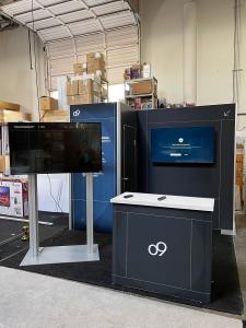 RENTAL: RE-1077 Inline Gravitee System Design with Storage Closet with Locking Door, Lightbox, RE-1586 Backlit Counter, Large Monitor Mount, RE-1229 Large Monitor Kiosk, (2) 55 Inch Monitors, and Silicone Edge Graphics