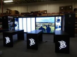Custom Wood and Gravitee Modular Inline Exhibit with Closet and Clothing Rod, Backlit Graphics, (2) Monitor Mounts, and (4) Modified MOD-1705 Parsons Counters with Backlit Logos
