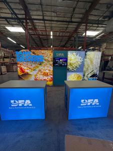 RENTAL: Inline Design with (2) 96" Wide x 95" High Double-Sided Lightboxes, (1) 38" Wide x 95" High Double-Sided Center Gravitee Panel, (2) RE-1567 Backlit Reception Counters with White Laminated Tops, (1) Large Monitor Mount, (1) 43" Monitor with HDMI Ca