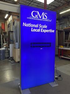 RENTAL: Modified RE-9096 Island Design with (1) 5 ft. Wide x 12 ft. High Double-Sided Lightbox, (2) 4 ft. Wide x 8 ft. High Double-Sided Lightboxes, (2) Curved Bridged Extrusion Headers, (2) Framed Frosted Acrylic Accent Wings, (3) Large Monitor Mounts, (