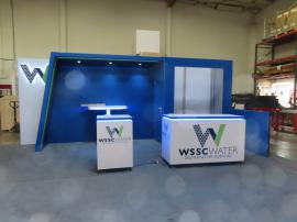 Custom Reconfigurable Gravitee Modular Exhibit with Halo Lit Dimensional Logo, Puck Lights, Backwall Charging Table, MOD-1593 Square Counter with LED Lights, and MOD-1599 Counter with LED Accent Lights -- View 2